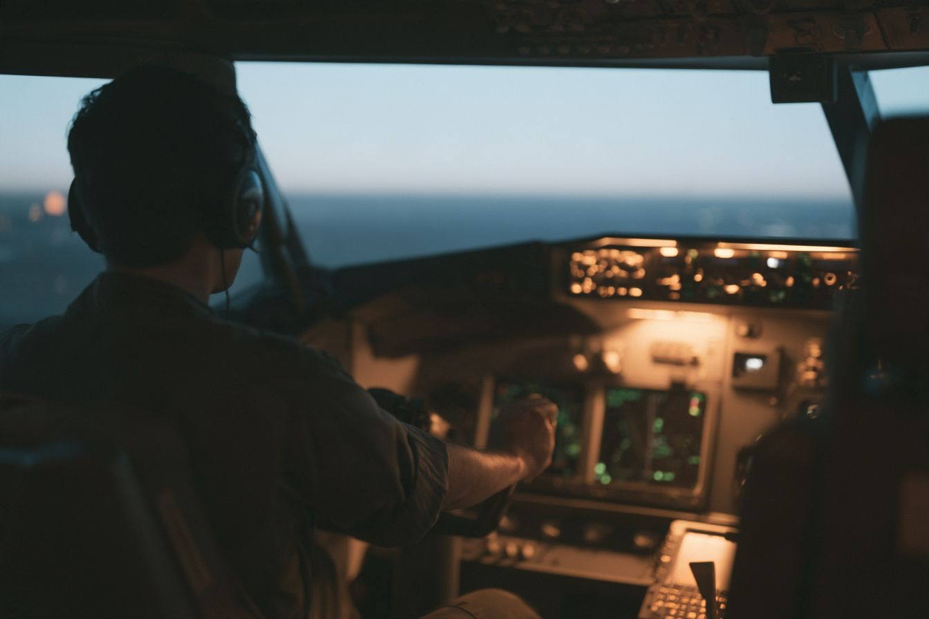 The interior of a full-motion flight simulator at dusk.