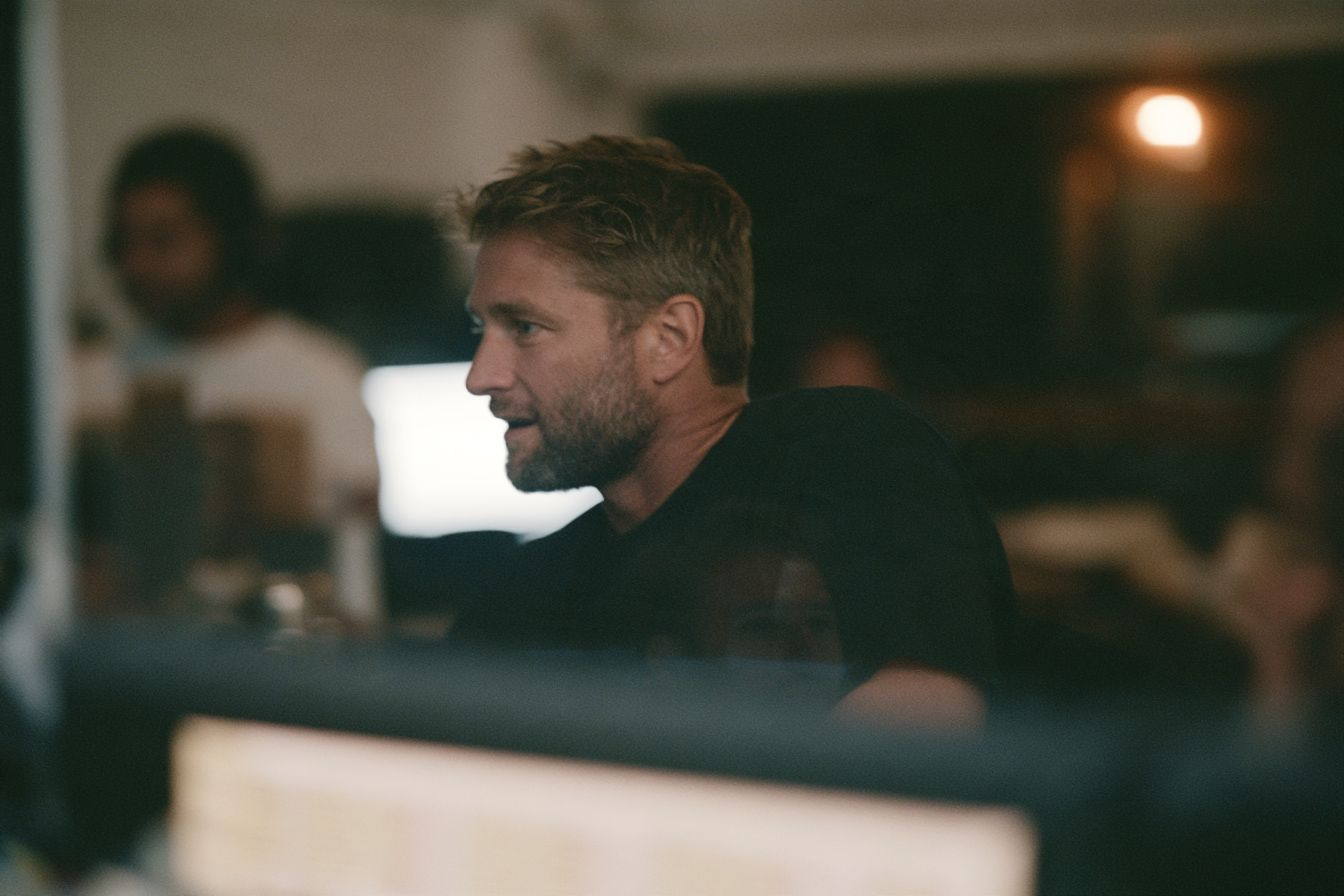 An instructor’s face lit by the screen in front of them.